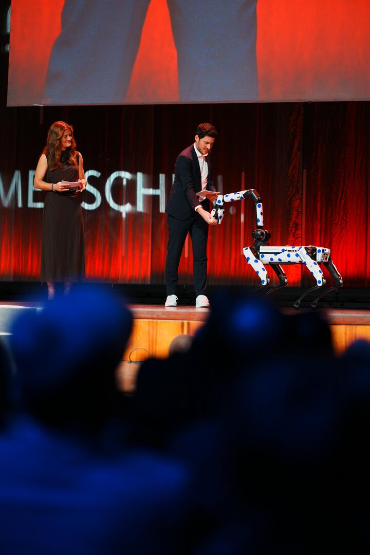 Die Moderation des Festakts Hockey-Nationalspielerin Sonja Zimmermann und Prof. Dr.-Ing. Oliver Wasenmüller, Professor an der Fakultät für Elektrotechnik an der Technischen Hochschule Mannheim, zusammen mit Roboterhündin Grace.