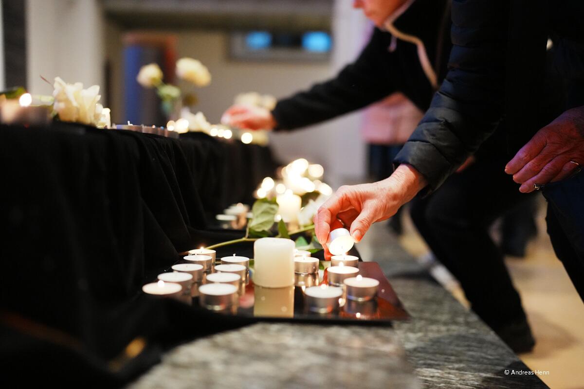 Menschen beim Kerzenaufstellen