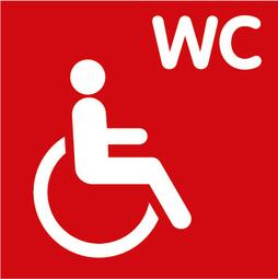 Vergrößerte Ansicht von Hier ist ein Symbol, das ein rollstuhlgerechtes WC anzeigt. Der Hintergrund ist ein rotes Quadrat, im Vordergrund ist eine Person, die im Rollstuhl sitzt und oben rechts stehen die Buchstaben WC. 
