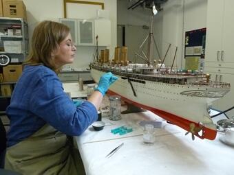 Vergrößerte Ansicht von Frau restauriert Modellschiff