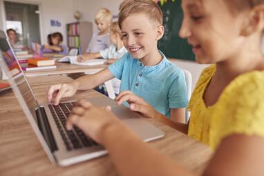 Vergrößerte Ansicht von Kinder benutzen Laptop in der Schule